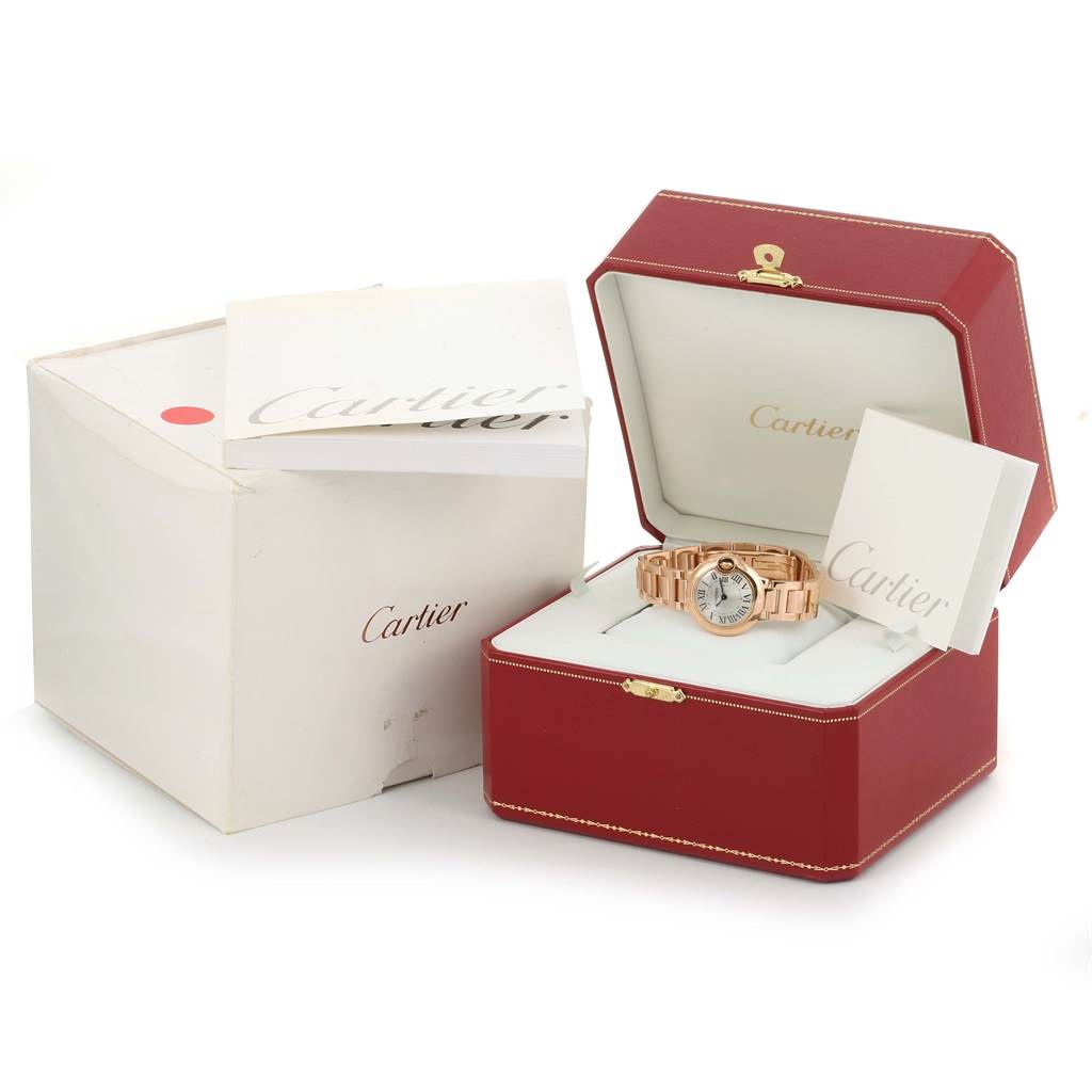 The image shows a Cartier Ballon Bleu W69002Z2 Women
s Rose Gold Silver Dial W69002Z2 Women
s Rose Gold Silver Dial watch inside its open red box, accompanied by a closed white outer box and booklets.