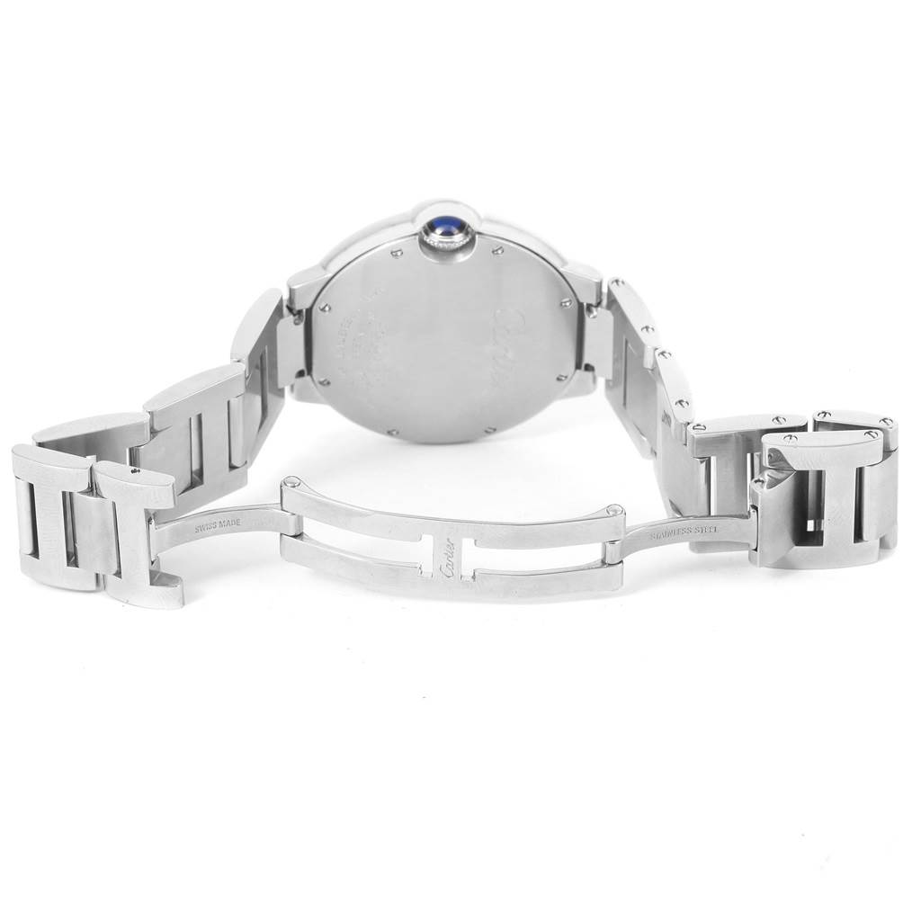 The image shows the back view of a Ballon Bleu by Cartier watch, highlighting its case and partially opened metal bracelet.