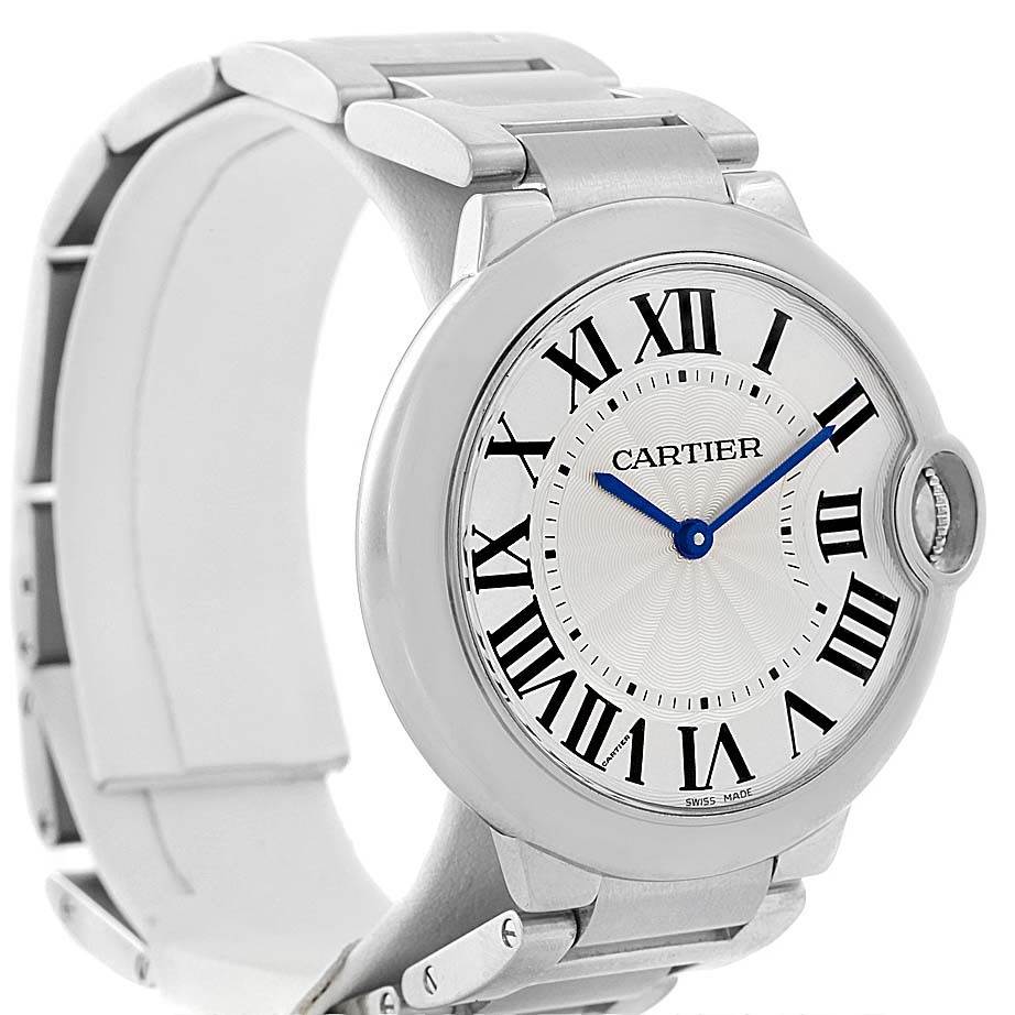 The image shows a Ballon Bleu de Cartier watch from a front-left angle, highlighting its face, strap, and clasp.