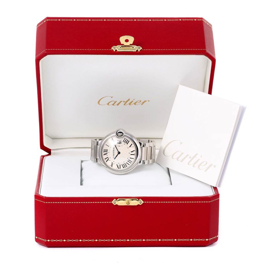The Cartier Ballon Bleu W69011Z4 Women
s Stainless Steel Silver Dial W69011Z4 Women
s Stainless Steel Silver Dial watch is displayed front-facing inside a red Cartier box, accompanied by a booklet.