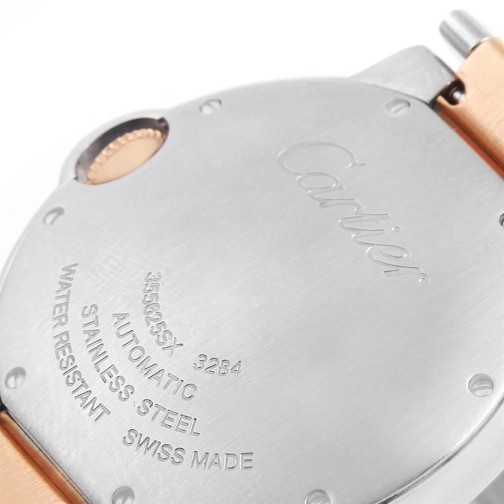 The image shows the back case of a Ballon Bleu watch model by Cartier, highlighting its stainless steel and automatic movement details.