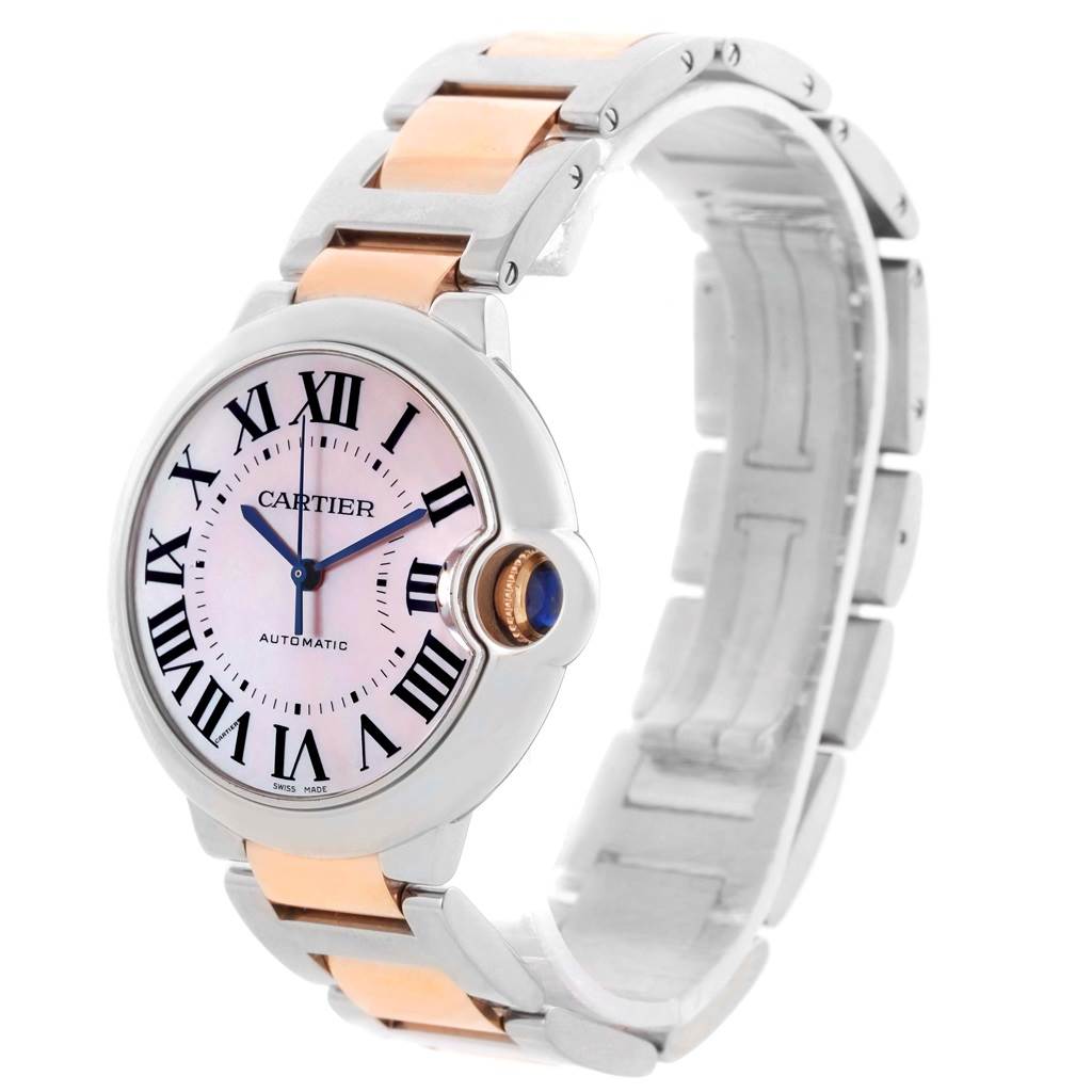The image shows a side angle of the Cartier Ballon Bleu W6920070 Women's Steel and Gold (two tone) Mother of Pearl Dial W6920070 Women's Steel and Gold (two tone) Mother of Pearl Dial watch, highlighting the face, crown, and two-tone bracelet.