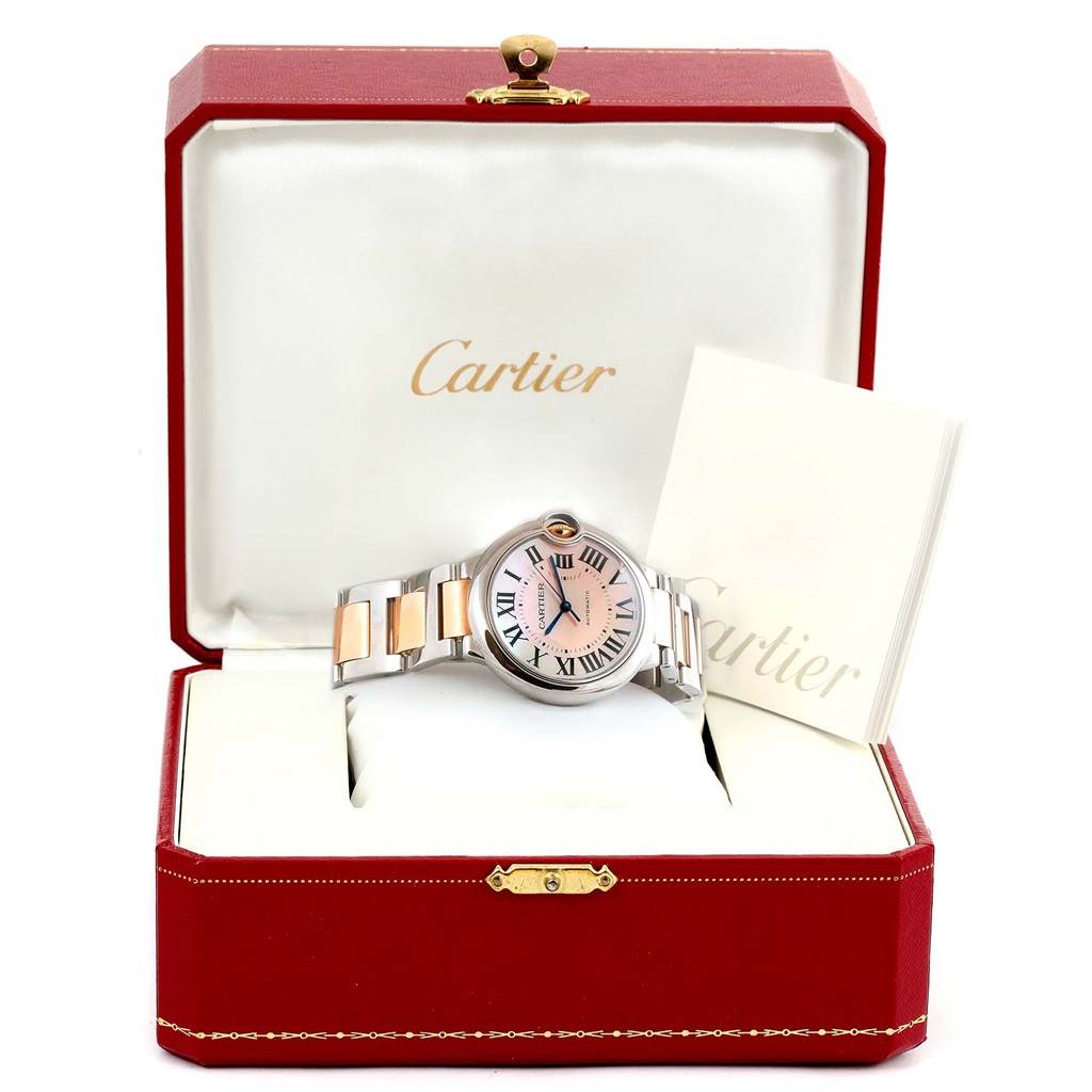 The Cartier Ballon Bleu W6920070 Women's Steel and Gold (two tone) Mother of Pearl Dial W6920070 Women's Steel and Gold (two tone) Mother of Pearl Dial watch is displayed face-up in an open red box with accompanying booklets.