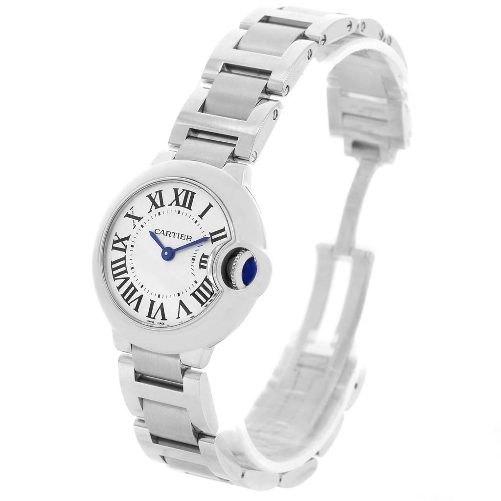 The image shows a Ballon Bleu model by Cartier at a three-quarter angle, highlighting the watch face, crown, and metal bracelet.