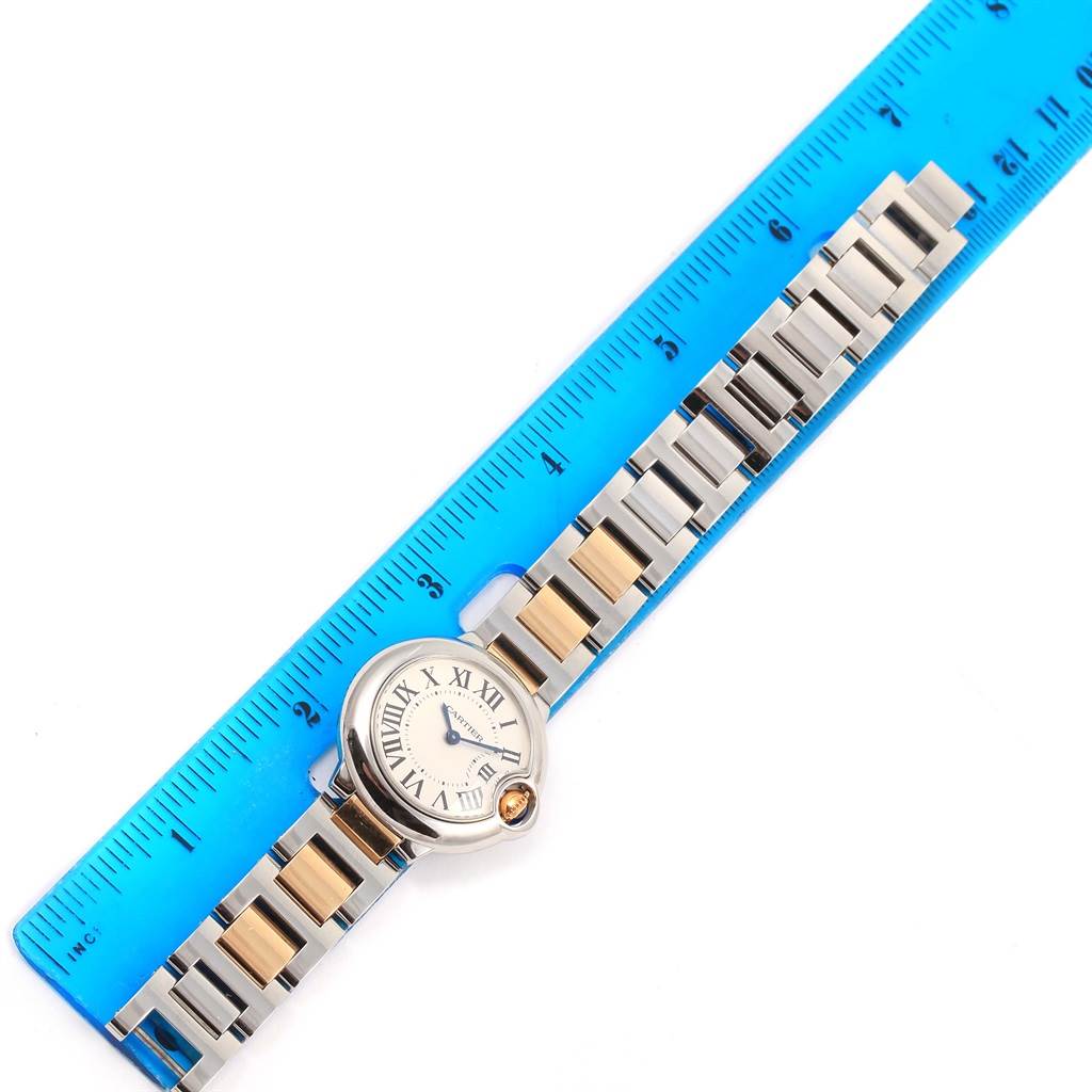 The image shows a Cartier Ballon Bleu W69007Z3 Women
s Silver Dial W69007Z3 Women
s Silver Dial watch laid flat next to a ruler, displaying its strap and face from a top-down angle.