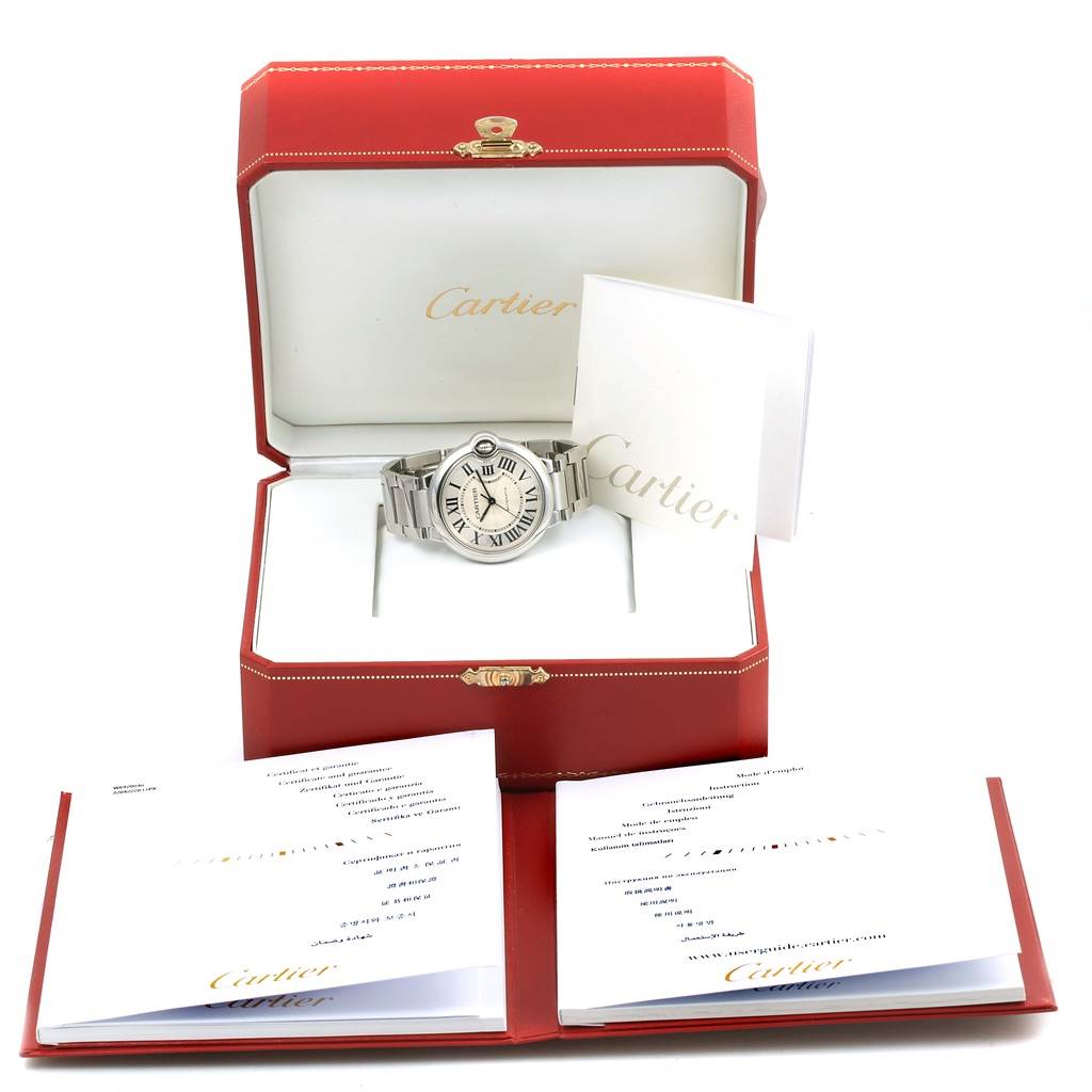 The image shows a Cartier Ballon Bleu W6920046 Women
s Stainless Steel Silver Dial W6920046 Women
s Stainless Steel Silver Dial watch in an open red Cartier box with accompanying booklets.