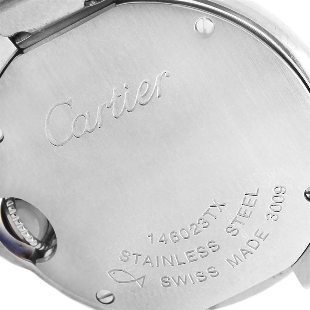 The image shows the back of a Ballon Bleu model watch by Cartier, highlighting the engravings and material details.