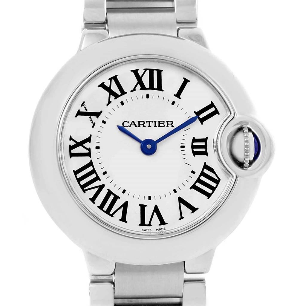 This image shows a close-up of the dial and part of the bracelet of a Cartier Ballon Bleu W69010Z4 Women's Stainless Steel Silver Dial W69010Z4 Women's Stainless Steel Silver Dial watch, with Roman numerals and a blue cabochon crown.