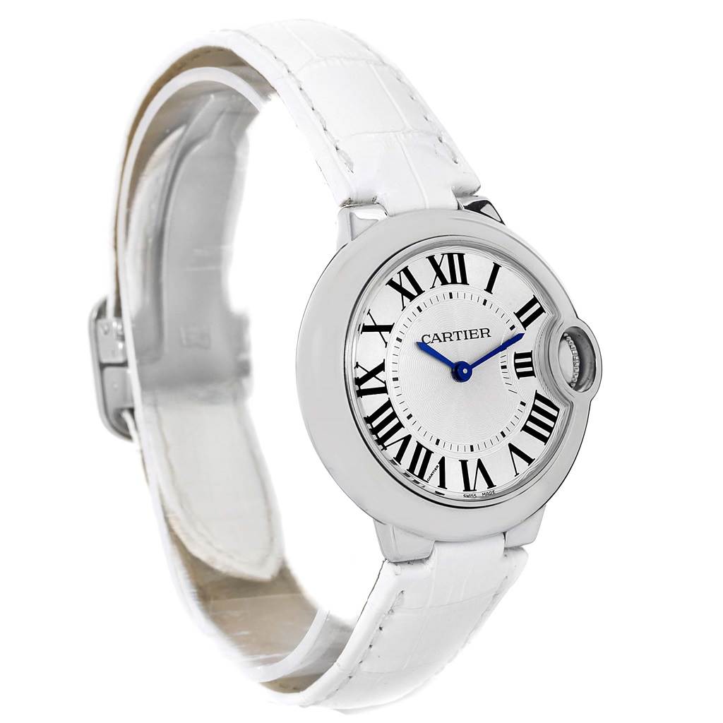 The image shows a side view of a Cartier Ballon Bleu W6920086 Women's Stainless Steel Silver Dial W6920086 Women's Stainless Steel Silver Dial watch featuring a white strap and a silver case with Roman numerals on the dial.