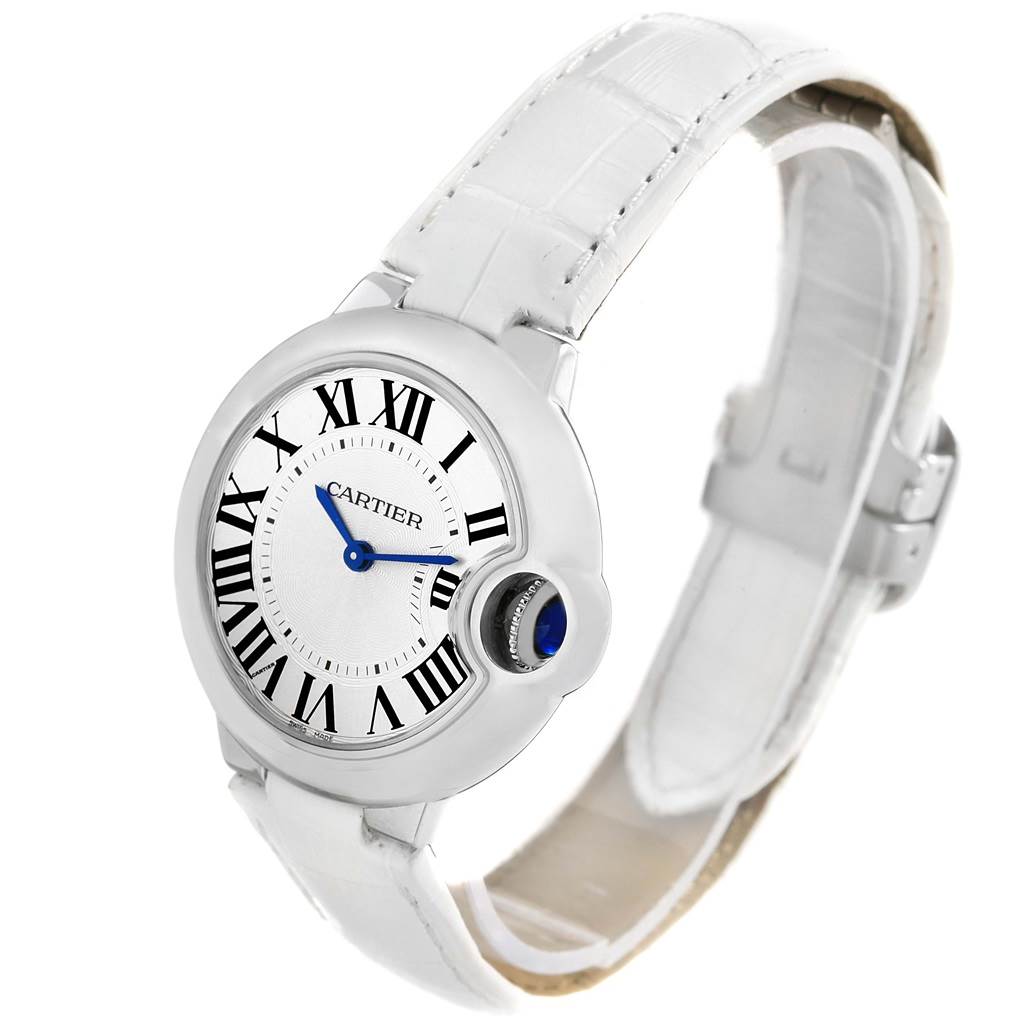 The image shows a side angle of the Cartier Ballon Bleu W6920086 Women's Stainless Steel Silver Dial W6920086 Women's Stainless Steel Silver Dial watch, displaying its face, crown, and white leather strap.