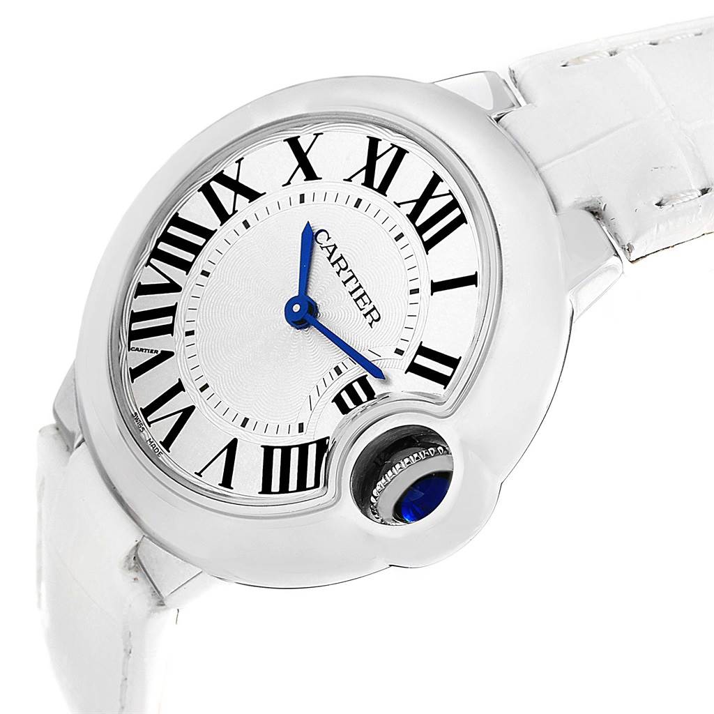 The image shows a close-up angled view of the Cartier Ballon Bleu W6920086 Women's Stainless Steel Silver Dial W6920086 Women's Stainless Steel Silver Dial watch, highlighting the face, Roman numerals, blue hands, and crown.