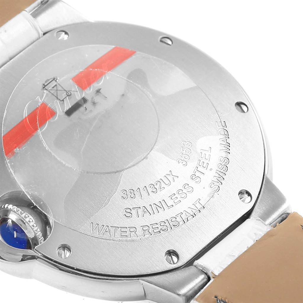 The image shows the back casing of the Ballon Bleu watch by Cartier, highlighting the stainless steel material and inscriptions.