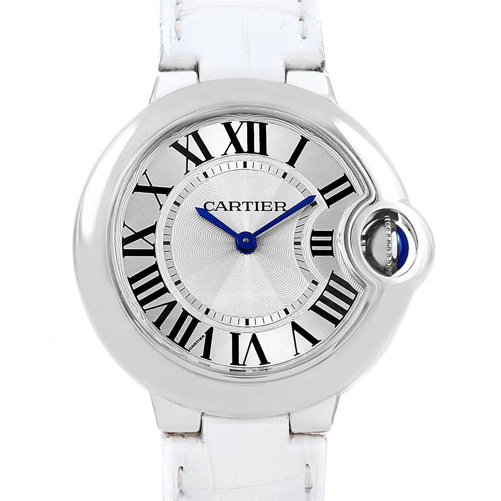 This is a front view of the Ballon Bleu watch by Cartier, showing its dial, Roman numerals, and white strap.