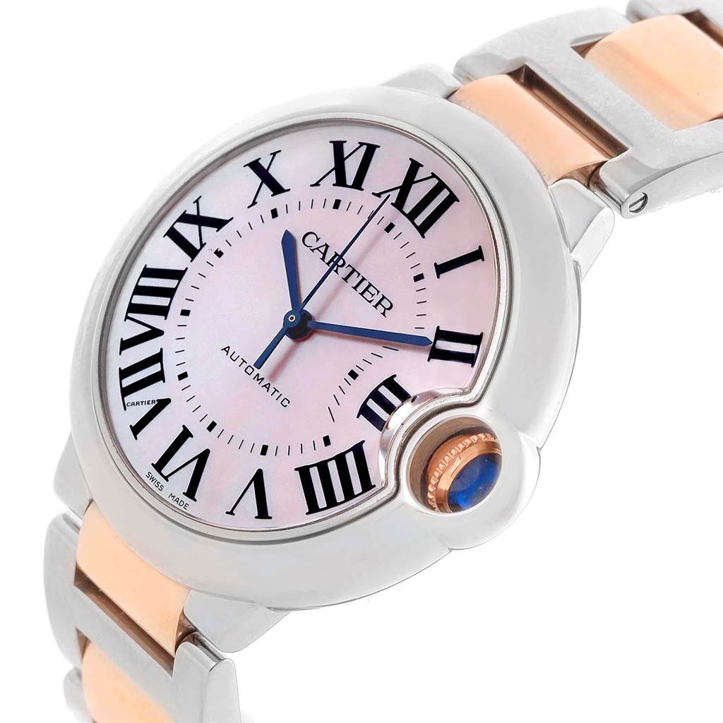 This image shows a close-up angled view of the Cartier Ballon Bleu W6920098 Women's Steel and Gold (two tone) Mother of Pearl Dial W6920098 Women's Steel and Gold (two tone) Mother of Pearl Dial watch face and part of its two-tone metal bracelet.