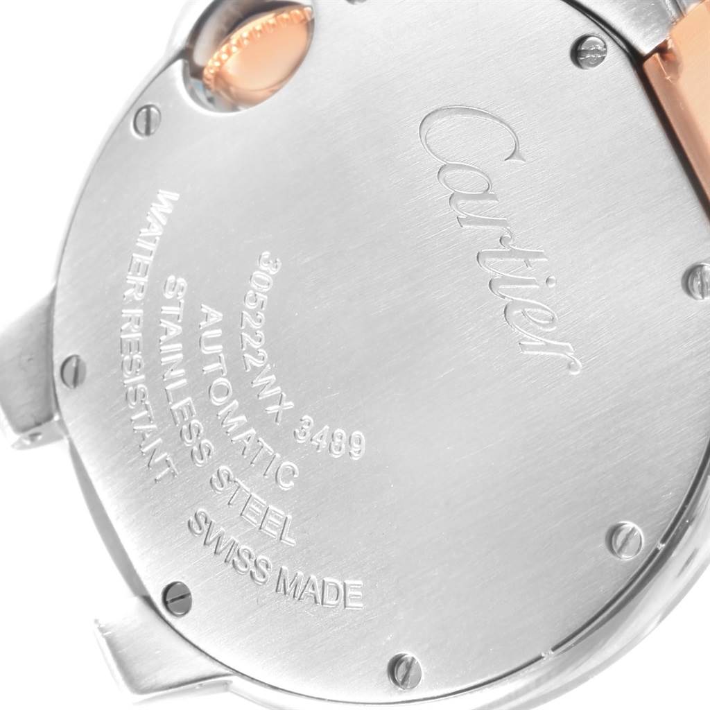 The image shows the back of a Cartier Ballon Bleu W6920098 Women's Steel and Gold (two tone) Mother of Pearl Dial W6920098 Women's Steel and Gold (two tone) Mother of Pearl Dial watch, featuring engraved text and stainless steel casing.