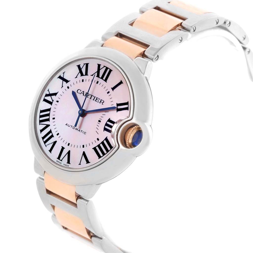 The image shows a side angle of a Cartier Ballon Bleu W6920098 Women's Steel and Gold (two tone) Mother of Pearl Dial W6920098 Women's Steel and Gold (two tone) Mother of Pearl Dial watch, highlighting its dial, bezel, crown, and bracelet.