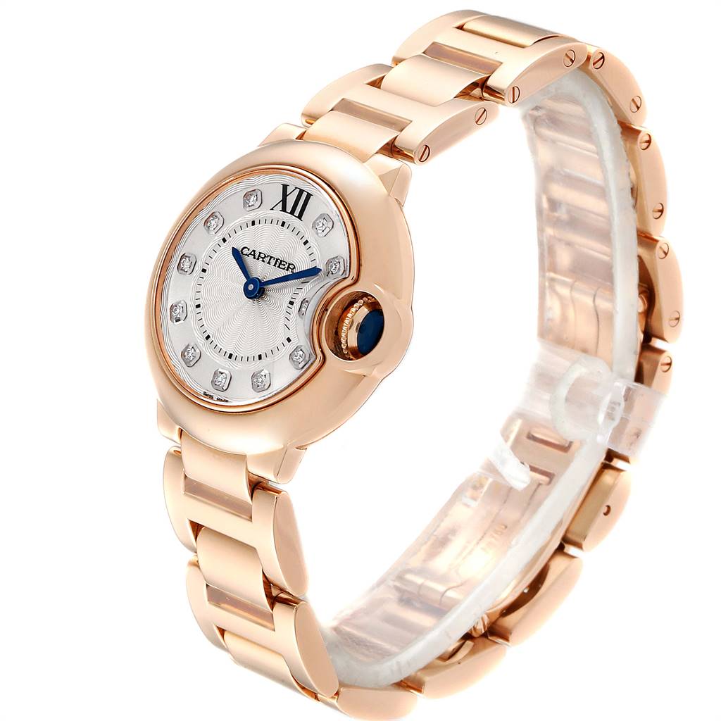 This image shows a rose gold Ballon Bleu watch by Cartier, angled to display the face, bezel, crown, and part of the bracelet.