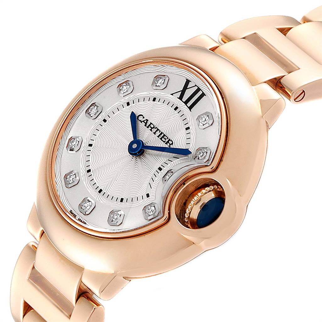 The image shows a close-up of the dial, crown, and bracelet of the Cartier Ballon Bleu WE902025 Women's Rose Gold Silver Dial WE902025 Women's Rose Gold Silver Dial watch from an angled view.