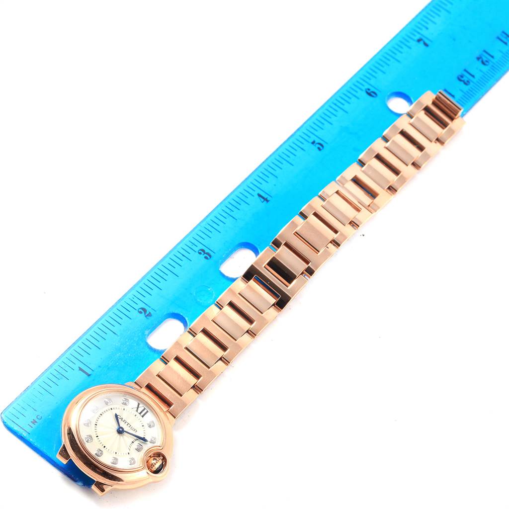 The image shows the full length of a Cartier Ballon Bleu WE902025 Women's Rose Gold Silver Dial WE902025 Women's Rose Gold Silver Dial watch with a ruler for scale.