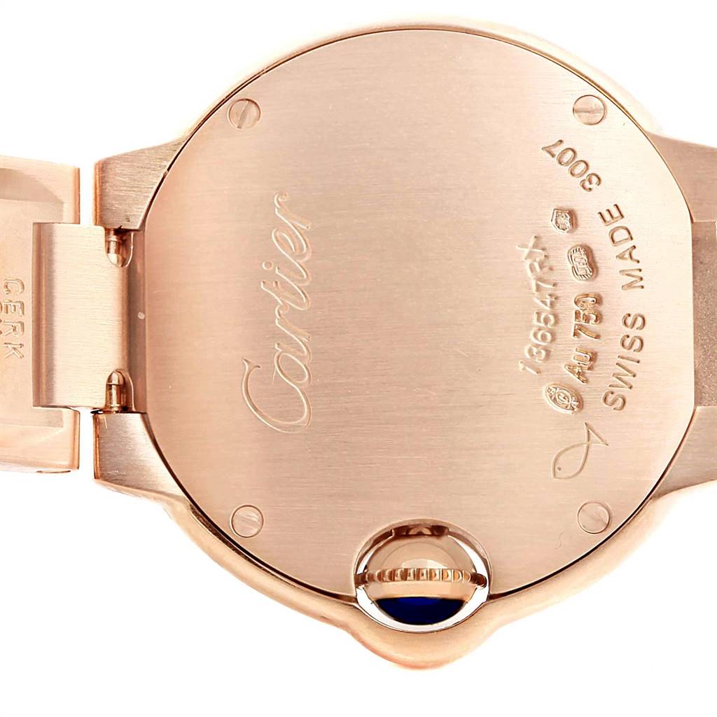 This image shows the back of a Ballon Bleu model by Cartier, highlighting the case back and the crown with a blue gemstone.