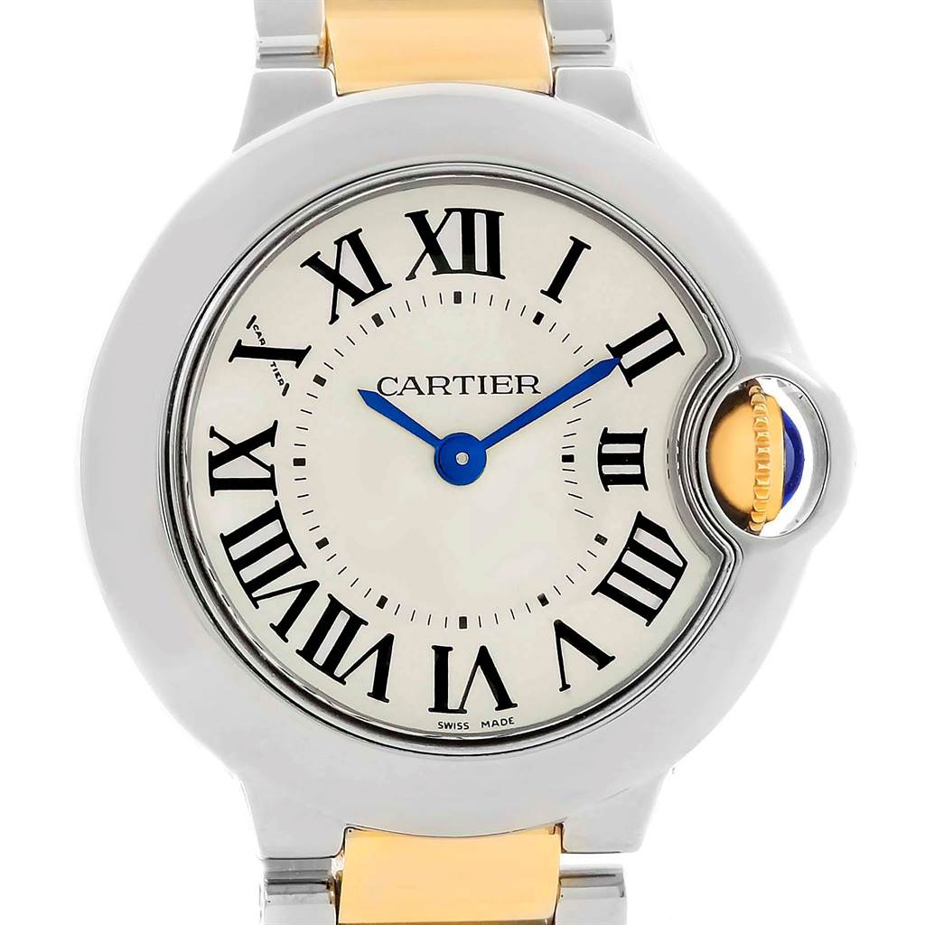 The image shows a close-up, frontal view of the dial and crown of the Ballon Bleu watch by Cartier.