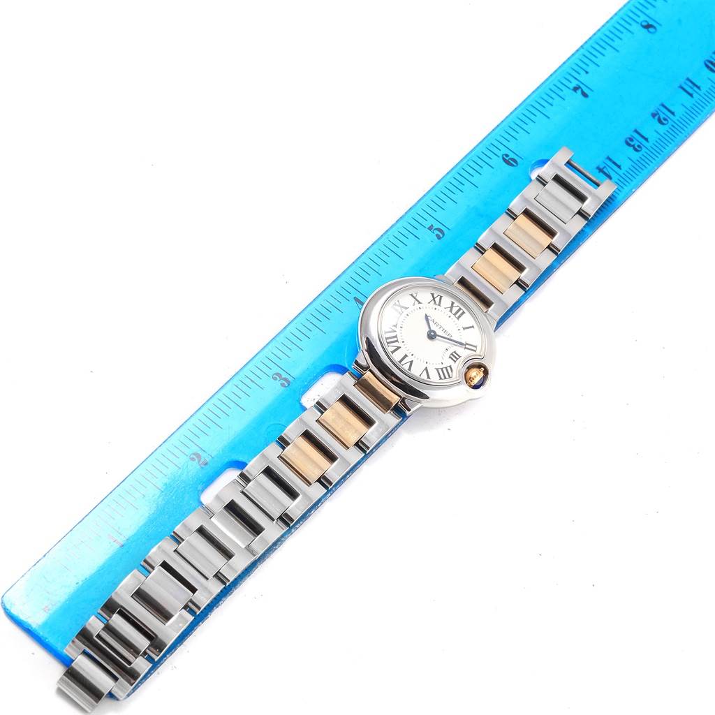 The image shows a Cartier Ballon Bleu W69007Z3 Women's Stainless Steel Silver Dial W69007Z3 Women's Stainless Steel Silver Dial watch laid flat next to a blue ruler for scale.