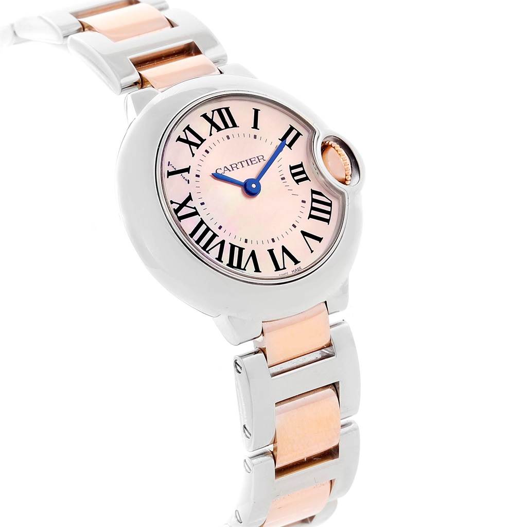 The image shows a top-down view of the Cartier Ballon Bleu W6920034 Women's Steel and Gold (two tone) Mother of Pearl Dial W6920034 Women's Steel and Gold (two tone) Mother of Pearl Dial watch, highlighting its round face, Roman numerals, and two-tone bracelet.