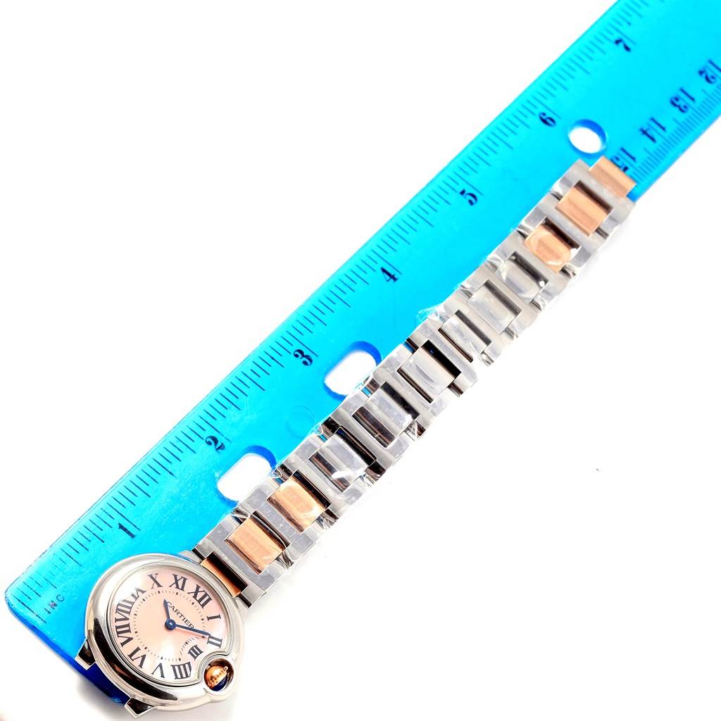 The image shows a Ballon Bleu de Cartier watch with a ruler, highlighting the bracelet and watch face.