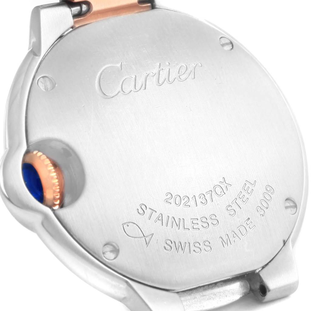 The image shows the back case of a Cartier Ballon Bleu W6920034 Women's Steel and Gold (two tone) Mother of Pearl Dial W6920034 Women's Steel and Gold (two tone) Mother of Pearl Dial watch, highlighting the engraved brand name, model number, and "stainless steel" mark.