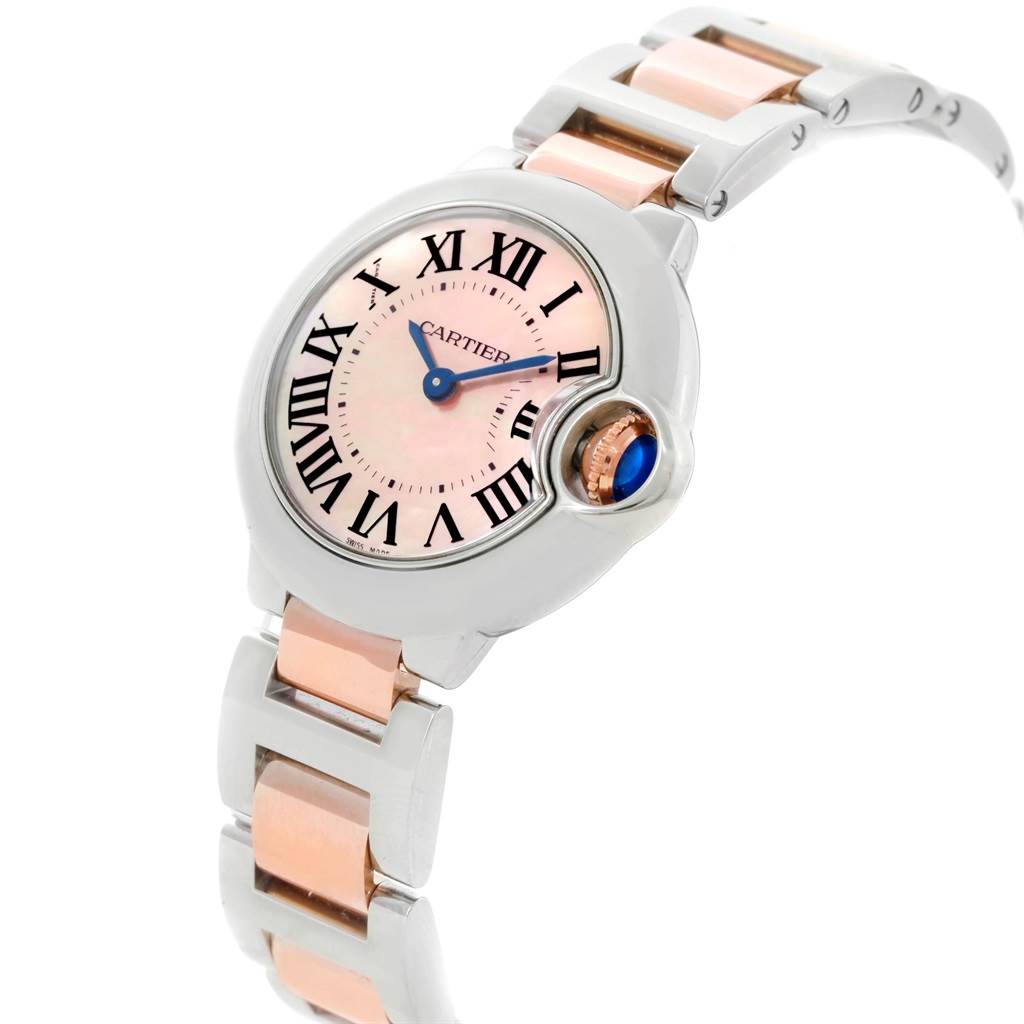 The image shows a side angle of the Cartier Ballon Bleu W6920034 Women's Steel and Gold (two tone) Mother of Pearl Dial W6920034 Women's Steel and Gold (two tone) Mother of Pearl Dial watch, highlighting its face, bezel, and metal bracelet.