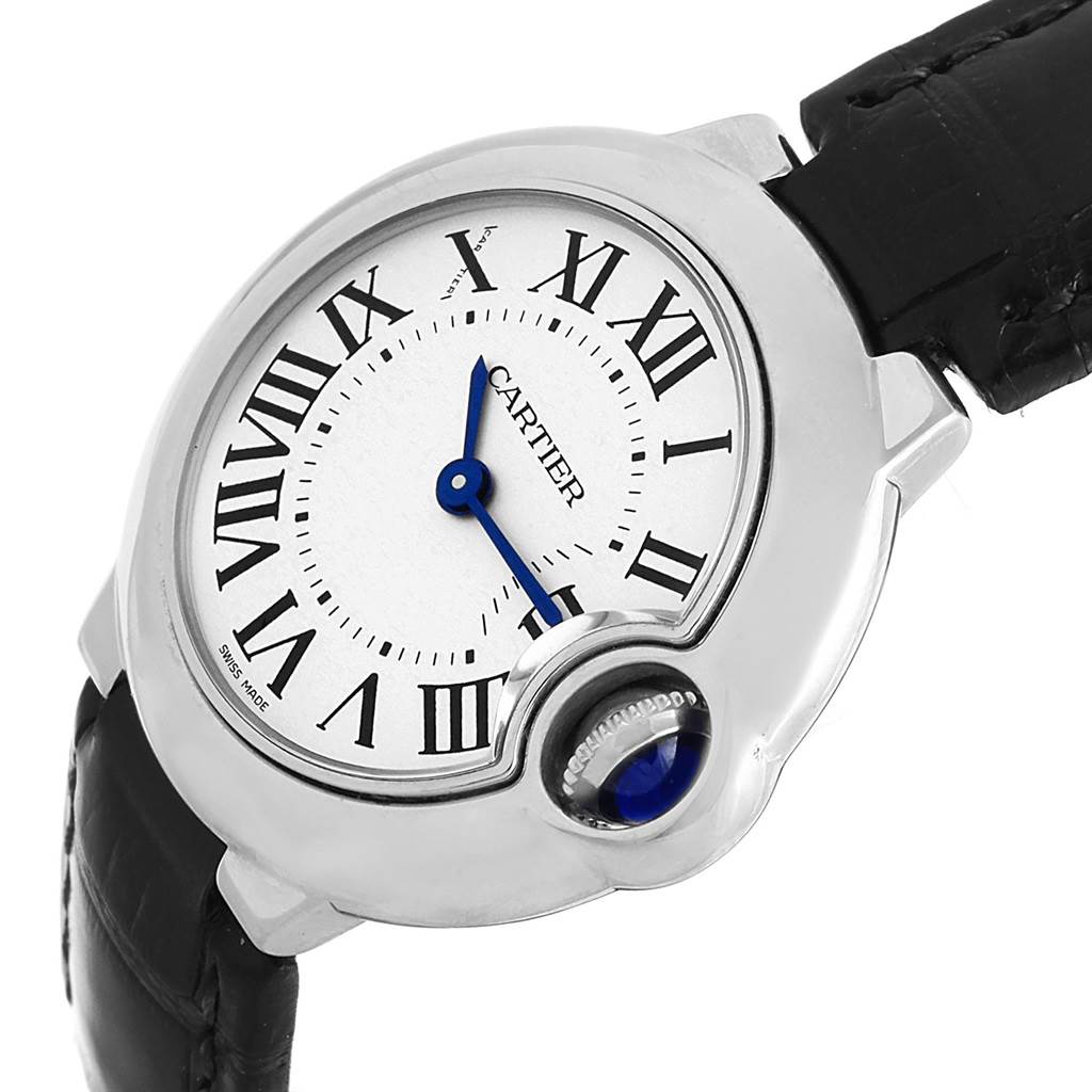 The Cartier Ballon Bleu W69018Z4 Women
s Stainless Steel Silver Dial W69018Z4 Women
s Stainless Steel Silver Dial watch is shown at an angle that highlights the dial, Roman numerals, and the crown with a blue cabochon.