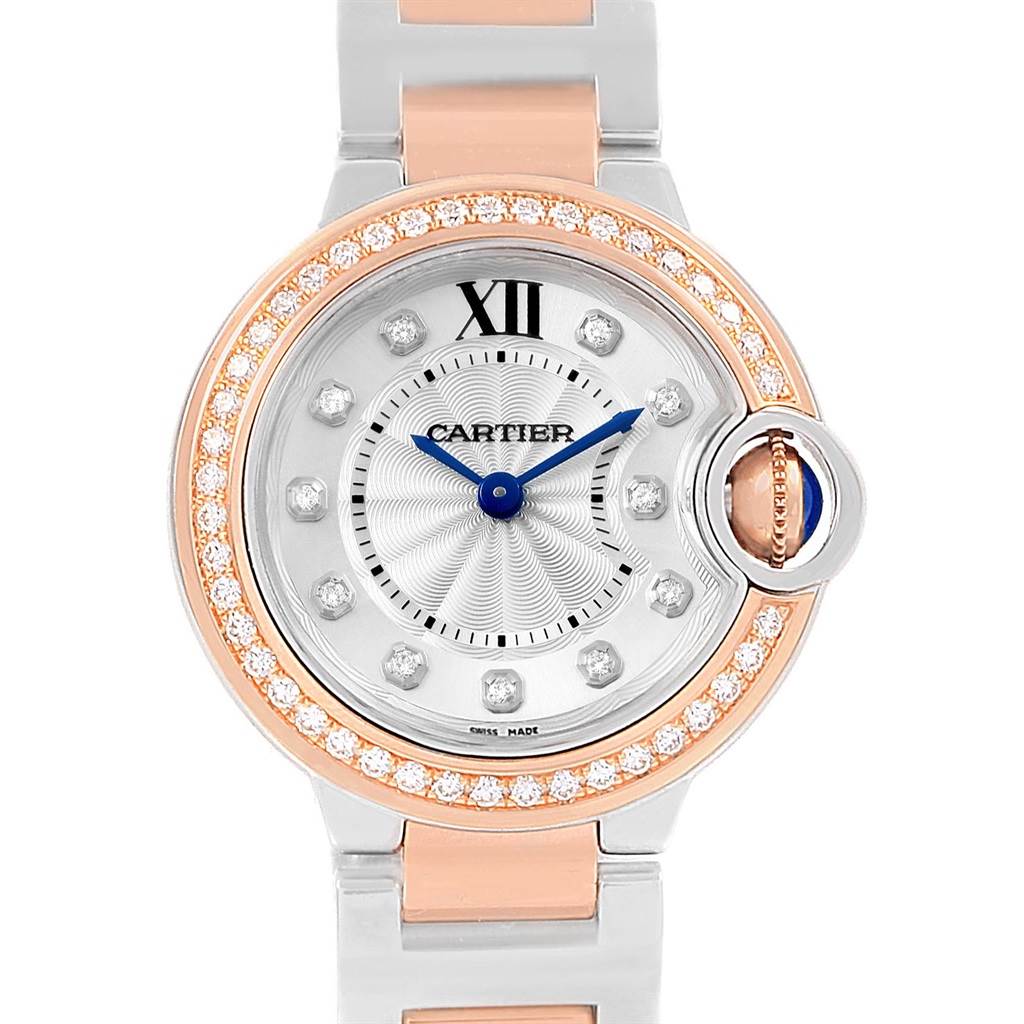 The image shows a front view of the Cartier Ballon Bleu WE902076 Women
s Steel and Gold (two tone) Silver Dial WE902076 Women
s Steel and Gold (two tone) Silver Dial watch, displaying its dial, bezel, hands, and part of the band.