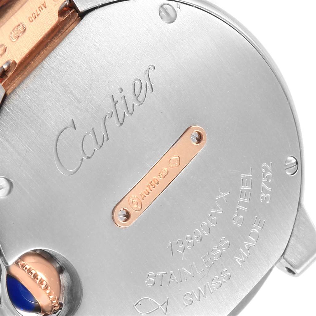 This image shows the back of a Cartier Ballon Bleu WE902076 Women
s Steel and Gold (two tone) Silver Dial WE902076 Women
s Steel and Gold (two tone) Silver Dial watch, highlighting the engravings and part of the crown.
