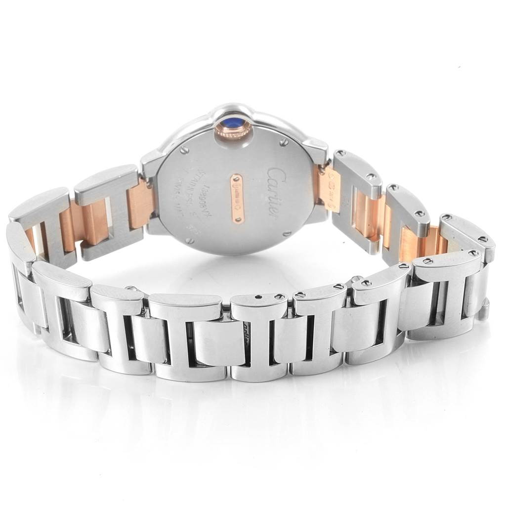 The image shows the back and partially open bracelet of the Cartier Ballon Bleu WE902076 Women
s Steel and Gold (two tone) Silver Dial WE902076 Women
s Steel and Gold (two tone) Silver Dial watch, highlighting the casing and clasp.