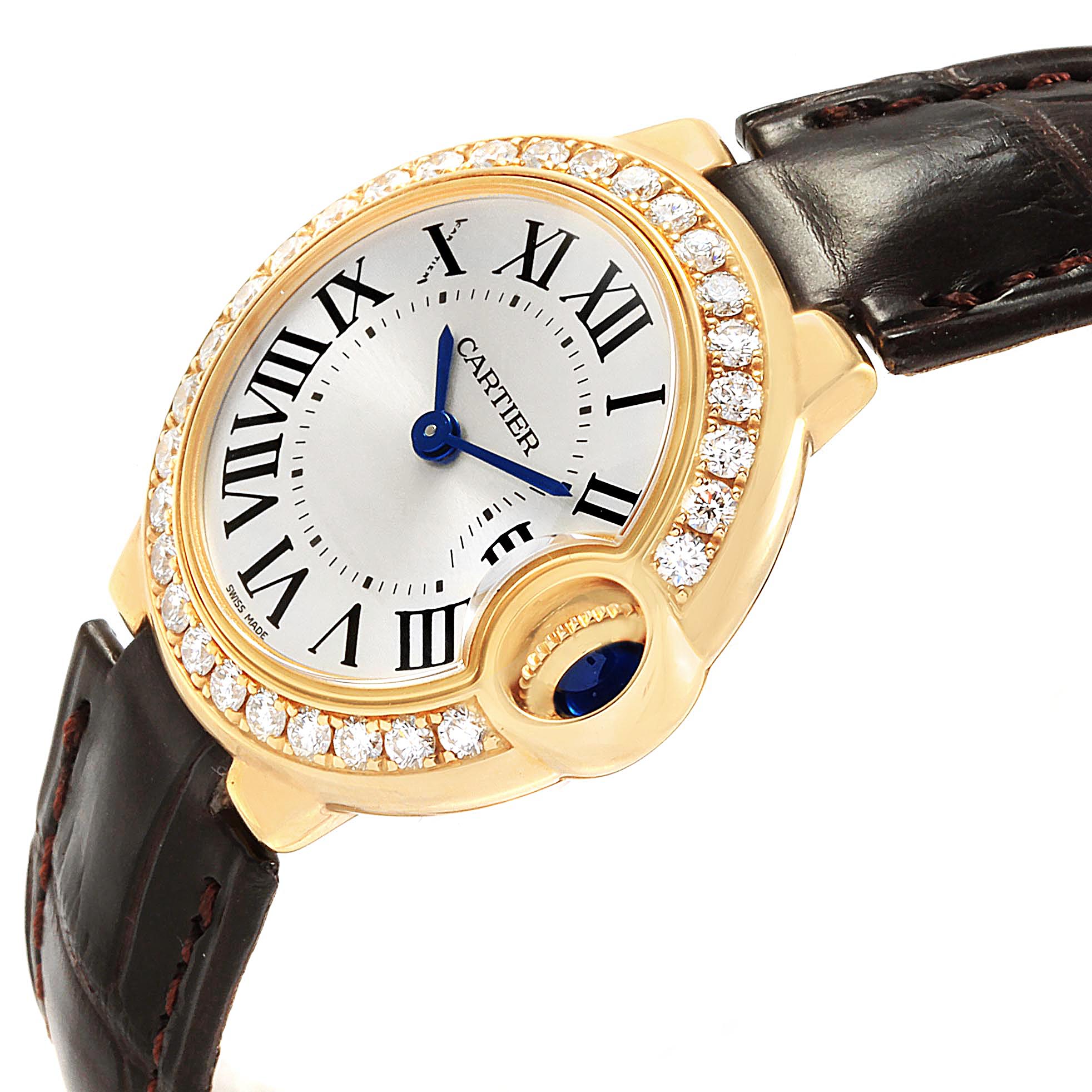 The image shows a Cartier Ballon Bleu WE900151 Women's Yellow Gold Silver Dial WE900151 Women's Yellow Gold Silver Dial watch at an angle highlighting its face, diamond-encrusted bezel, and leather strap.