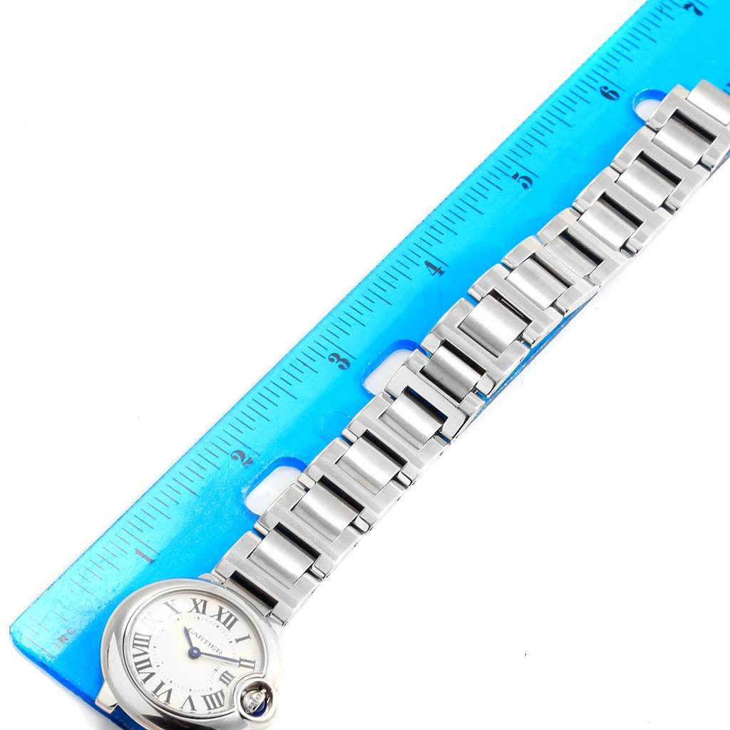 The Cartier Ballon Bleu W69010Z4 Women
s Stainless Steel Silver Dial W69010Z4 Women
s Stainless Steel Silver Dial watch is displayed from an overhead angle, showing its face and bracelet alongside a ruler for scale.