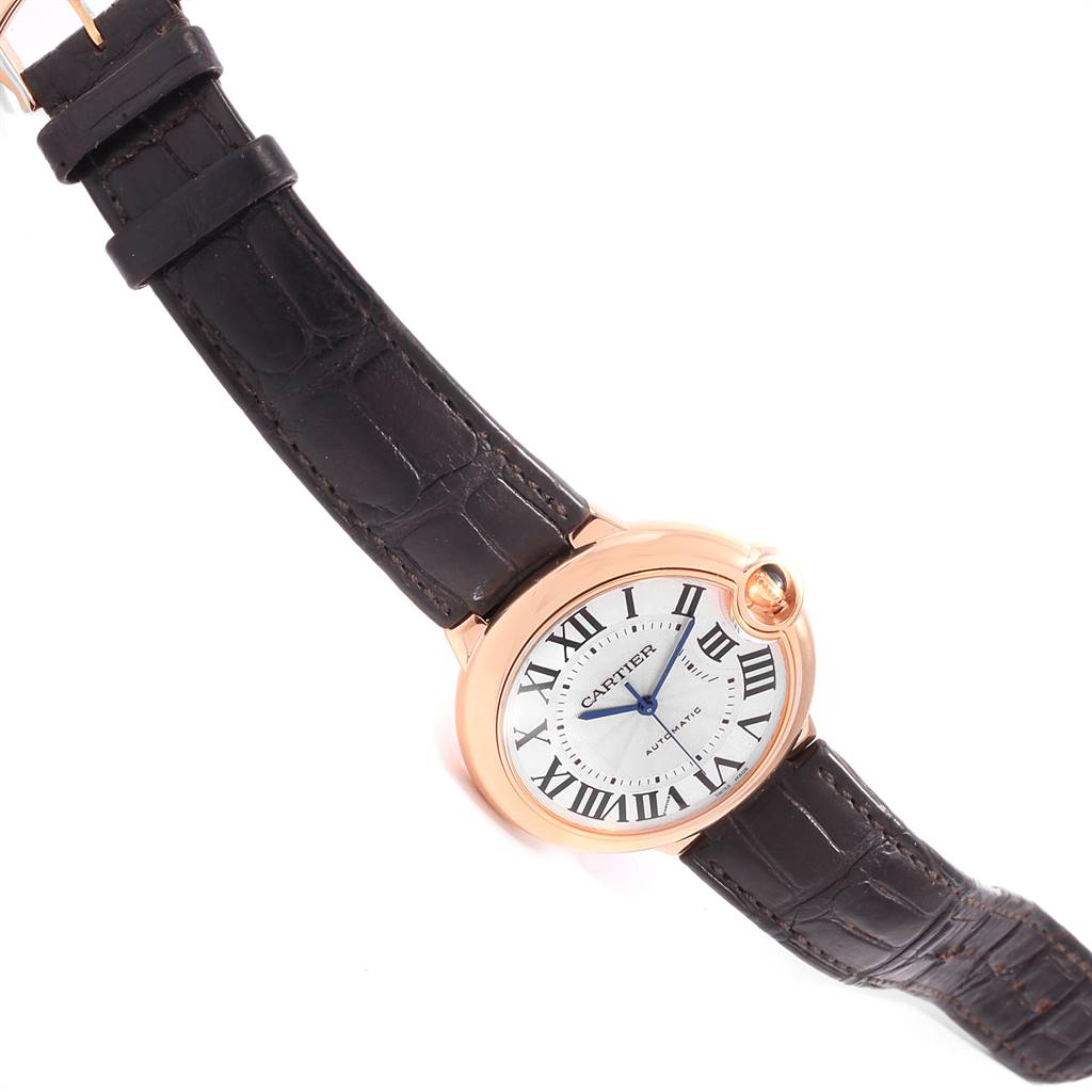 The Cartier Ballon Bleu WGBB0009 Men's Rose Gold Silver Dial WGBB0009 Men's Rose Gold Silver Dial watch is shown at a slightly tilted angle, displaying the face, strap, and winding crown.