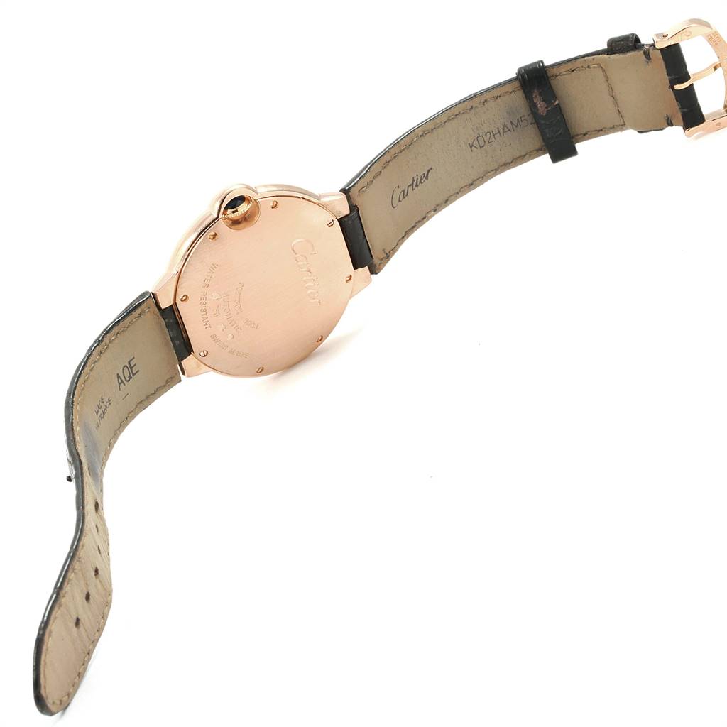 This Cartier Ballon Bleu WGBB0009 Men's Rose Gold Silver Dial WGBB0009 Men's Rose Gold Silver Dial watch is shown from the back, displaying its leather strap and case back.
