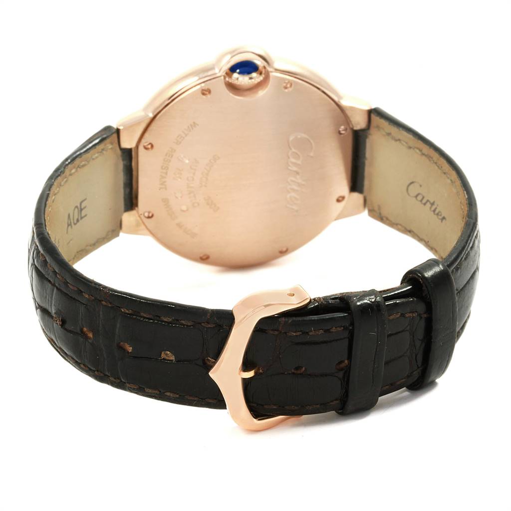 The image shows the back view of a Cartier Ballon Bleu WGBB0009 Men's Rose Gold Silver Dial WGBB0009 Men's Rose Gold Silver Dial watch, highlighting the case back, leather strap, and clasp.