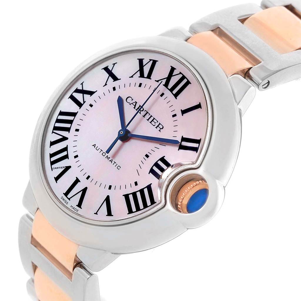 This Cartier Ballon Bleu W6920070 Women's Steel and Gold (two tone) Mother of Pearl Dial W6920070 Women's Steel and Gold (two tone) Mother of Pearl Dial watch is shown from a three-quarter angle displaying its face, Roman numerals, and metal band.