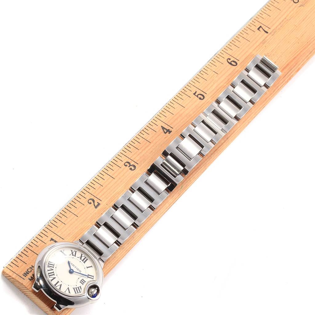 The image displays a Cartier Ballon Bleu W69010Z4 Women
s Stainless Steel Silver Dial W69010Z4 Women
s Stainless Steel Silver Dial watch placed alongside a ruler, highlighting the face and stainless steel bracelet.