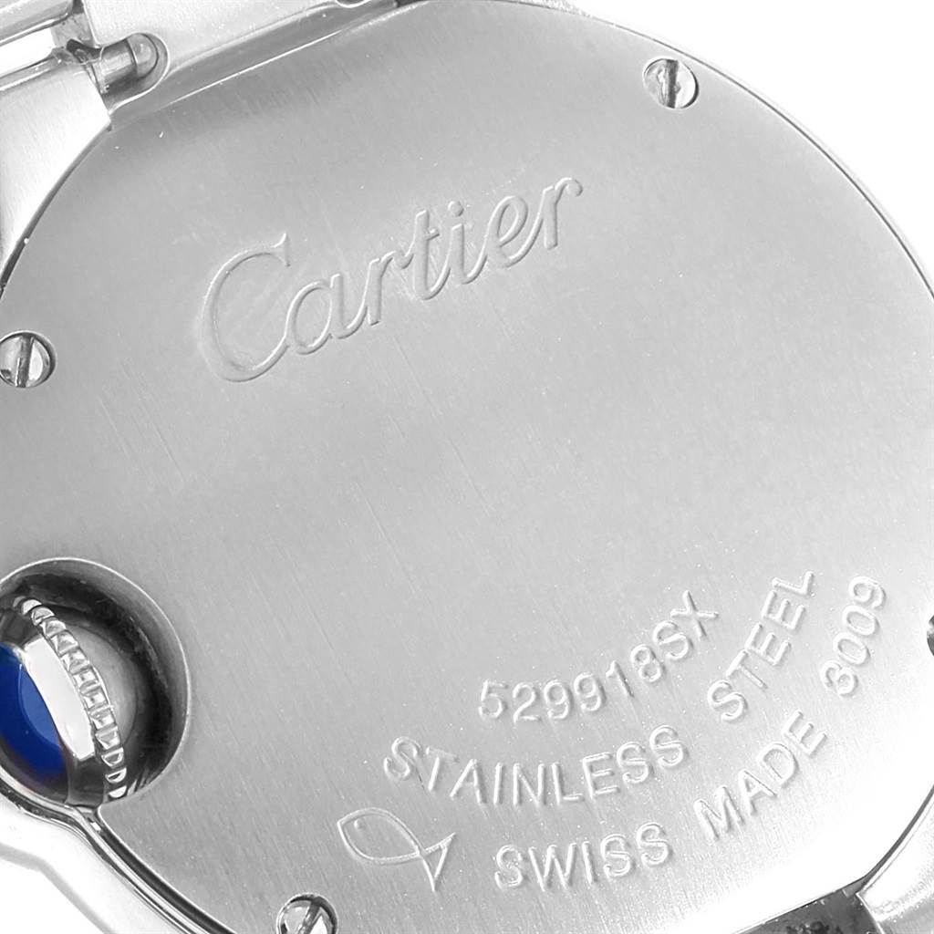 This image shows the back case of a Ballon Bleu watch by Cartier, highlighting engravings and the crown with a blue cabochon.