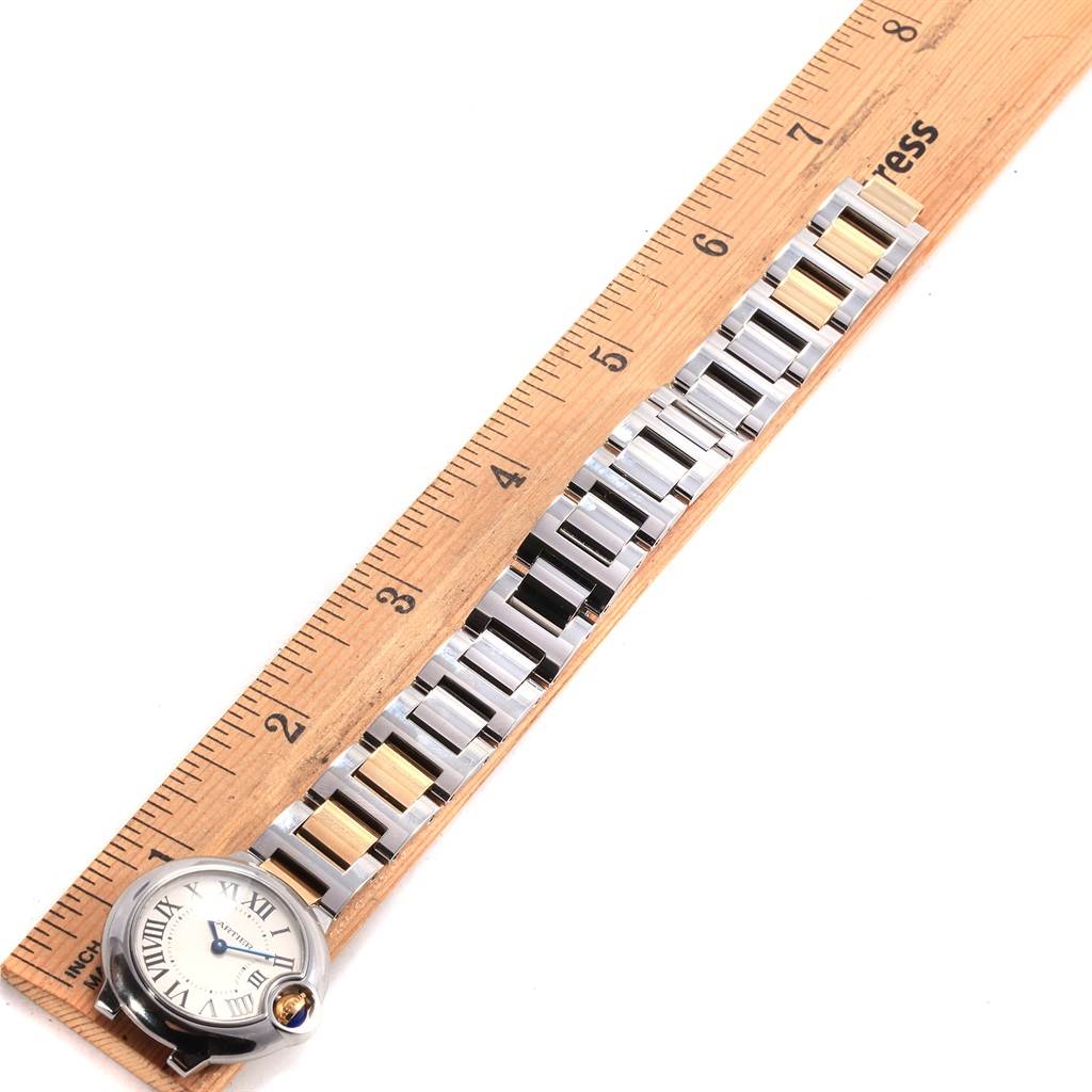 The image shows a Cartier Ballon Bleu W69007Z3 Women
s Stainless Steel Silver Dial W69007Z3 Women
s Stainless Steel Silver Dial watch laid flat next to a ruler, highlighting its bracelet and face.
