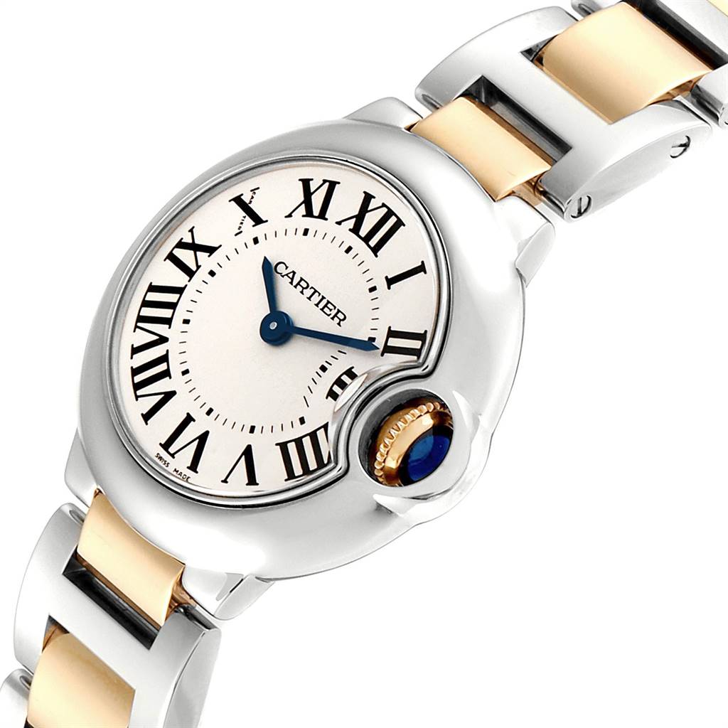 This image shows a close-up of the Cartier Ballon Bleu W69007Z3 Women's Steel and Gold (two tone) Silver Dial W69007Z3 Women's Steel and Gold (two tone) Silver Dial watch's face, crown, and part of the bracelet.
