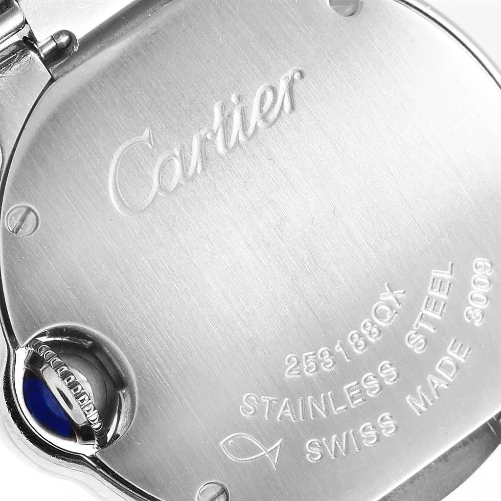 The image shows the back case of a Cartier Ballon Bleu W69010Z4 Women
s Stainless Steel Silver Dial W69010Z4 Women
s Stainless Steel Silver Dial watch, which is made of stainless steel with engravings and a blue cabochon crown.
