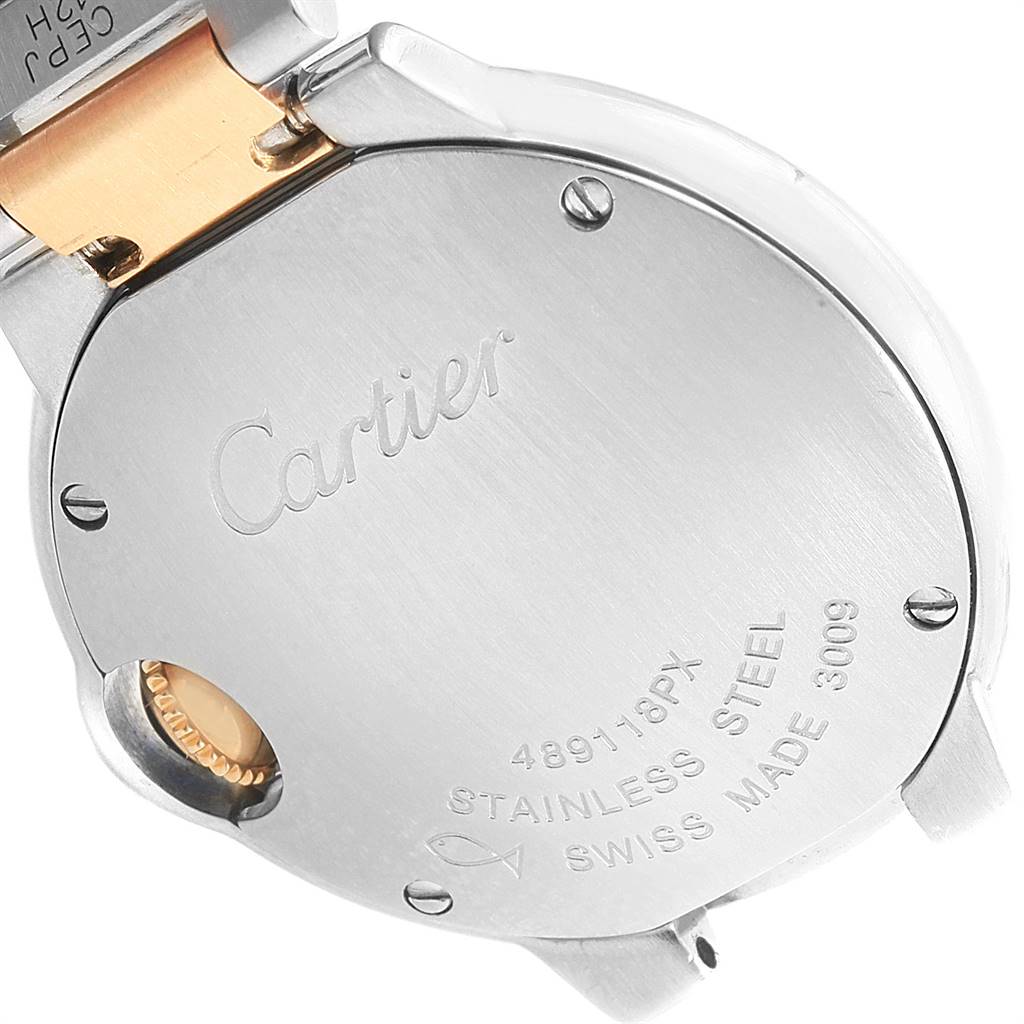 The image shows the back case of a Cartier Ballon Bleu W69007Z3 Women
s Stainless Steel Silver Dial W69007Z3 Women
s Stainless Steel Silver Dial watch viewed at an angle, revealing engravings and connecting parts.