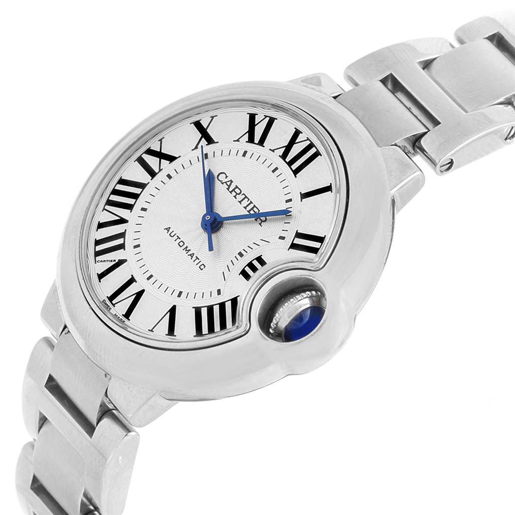 The image shows a side angle of the Cartier Ballon Bleu W6920071 Women
s Stainless Steel Silver Dial W6920071 Women
s Stainless Steel Silver Dial watch, highlighting its face, blue hands, Roman numerals, and metal bracelet.