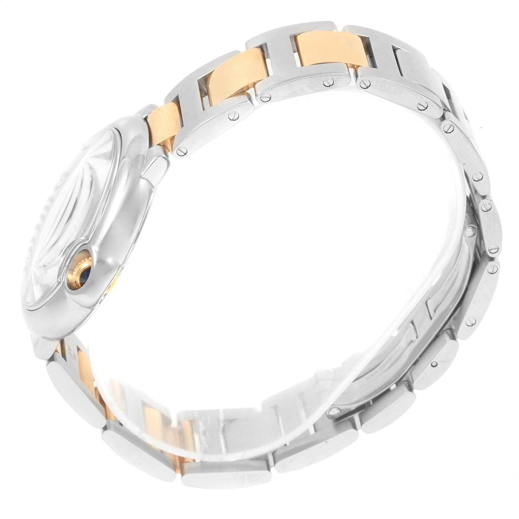 This image shows the side angle of a Cartier Ballon Bleu W69008Z3 Men
s Steel and Gold (two tone) Silver Dial W69008Z3 Men
s Steel and Gold (two tone) Silver Dial watch, highlighting the bezel, crown, and two-tone metal links of the bracelet.