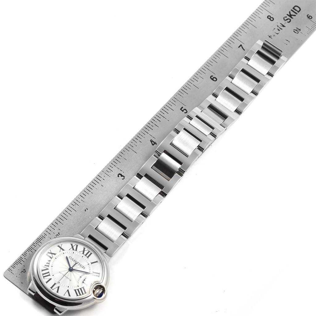 The image shows the Ballon Bleu by Cartier watch laid flat with a metal ruler measuring its bracelet length.