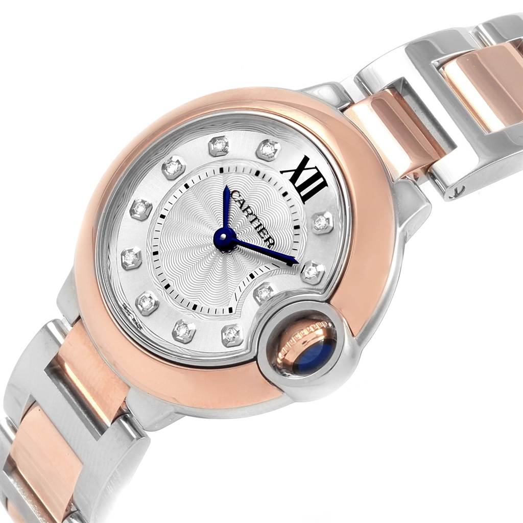 The image shows a Cartier Ballon Bleu W3BB0005 Women
s Steel and Gold (two tone) Silver Dial W3BB0005 Women
s Steel and Gold (two tone) Silver Dial watch at an angle highlighting the face, crown, and part of the metal bracelet.